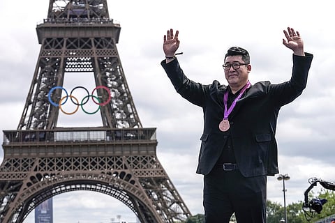 2012 London Olympic men's weightlifting +105kg event: Sangguen Jean of South Korea poses with his bronze medal